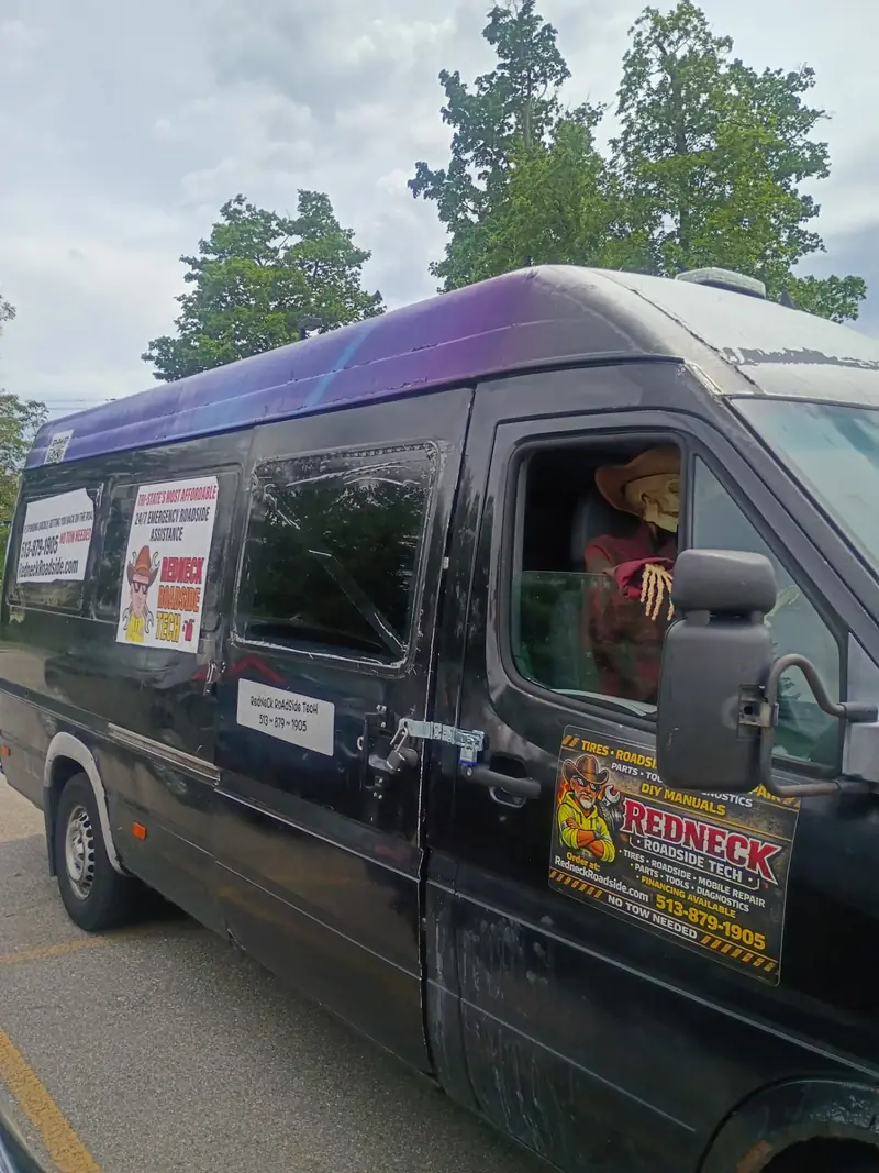Redneck Roadside Tech mobile tire service van with company signage parked on a Cincinnati street